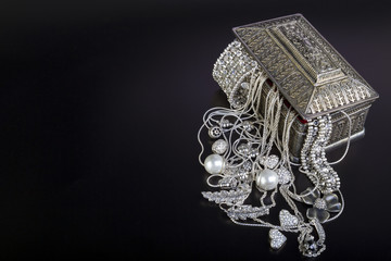 Silver jewelry on black background