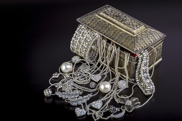 Silver jewelry on black background