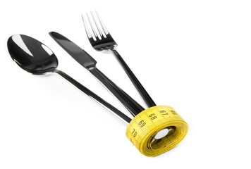 measuring tape with spoon, knife and fork,nutrition and diet