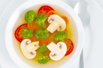 Mushroom soup with vegetables on white background