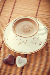 Cup of coffee and chocolate candy in vintage style
