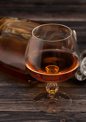 Glass of brandy on dark background