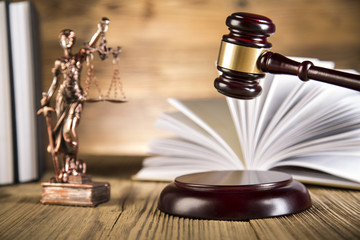 Lady of justice, wooden & gold gavel and books on wooden table