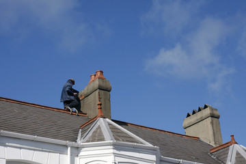 Fototapeta na wymiar Workman repairing a chimney stack