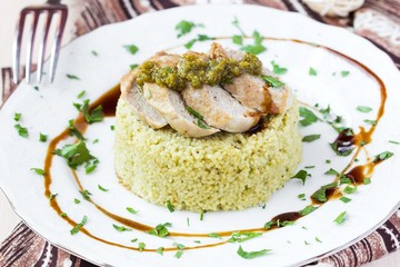 Couscous with pesto sauce, fried sliced pork, tasty dish