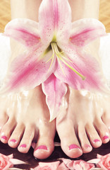 Spa background with beautiful legs and flowers