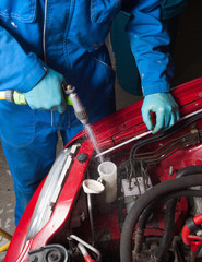 Man filling the water tank of the car