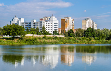 Fototapeta na wymiar Residential buildings over a lake. Kyiv, Ukraine