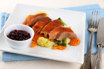Roasted duck breast with vegetables, wild blueberries