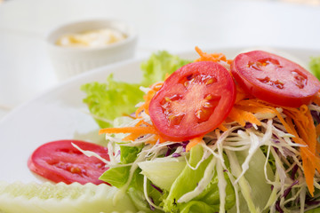 Vegetable salad on white plate.