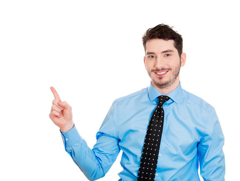 Handsome businessman pointing at blank copy space