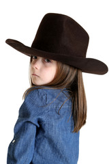 young cowgirl looking over her shoulder with a tough look