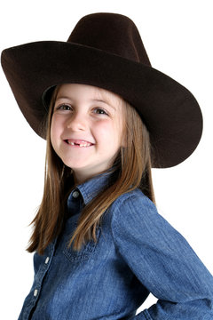 Cute young cowgirl missing her front teeth smiling