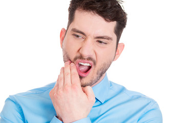Toothache. Young man having sensitive teeth, pain
