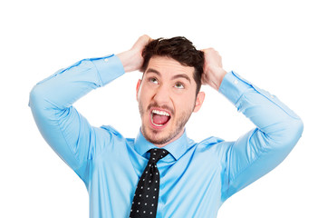 Portrait Stressed man pulling his hair out, white background 