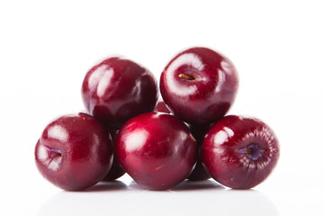 plums isolated on white