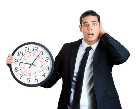 Businessperson running out of time, holding clock