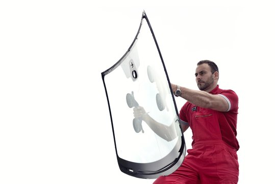 mechanic holding windshield
