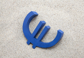 Blue euro symbol in the sand