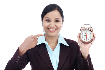 Young business woman with an alarm clock