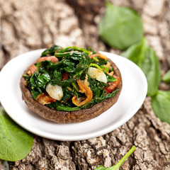 Stuffed mushroom with spinach and bacon. Selective focus. Macro.