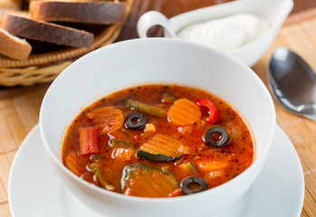 Vegetables soup in plate on table