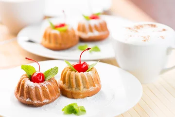 Tuinposter Cakes dessert with cappuccino coffee cup © Andrey Kuzmin