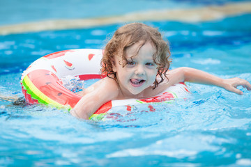 little boy in the swimming pool  with rubber ring