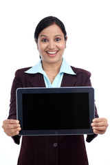 Young business woman showing black screen of  tablet computer