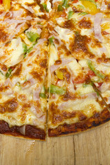 slice cheese of pizza is lifted from the pan