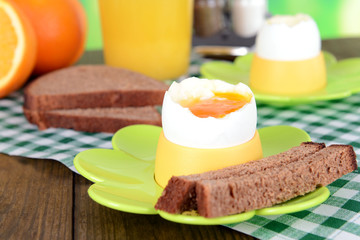 Boiled eggs in egg cups on table close-up