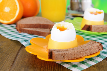 Boiled eggs in egg cups on table close-up