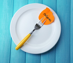 Note paper with message  attached to fork,