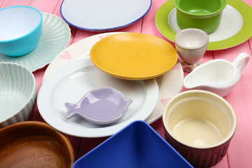 Different tableware on wooden background