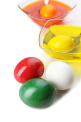 Bowls with paint for Easter eggs and eggs, isolated on white