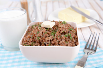 Boiled buckwheat in bowl on table close-up