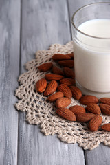 Almond milk in jug with almonds in bowl,