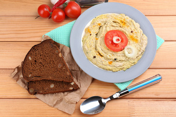 Bowl of tasty fresh hummus with tomatoes