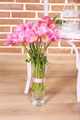 Beautiful pink tulips on brick wall background