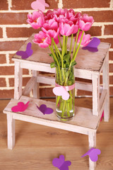 Composition with bouquet of tulips in vase,