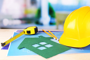 House of felt and drawings on table on bright background