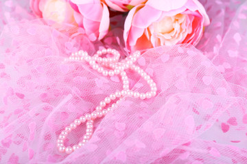 Beautiful pearls on pink cloth