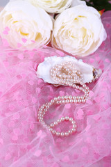 Beautiful pearls in shell on pink cloth