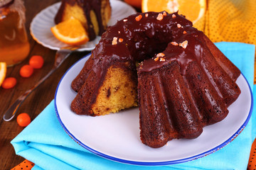 Tasty homemade pie with oranges on table close-up