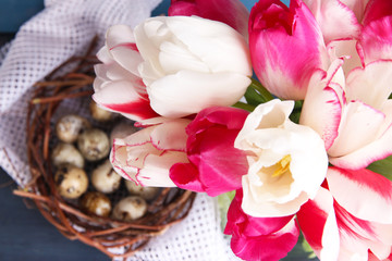 Composition with Easter eggs and beautiful tulips in glass jug
