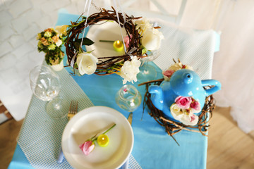 Beautiful holiday Easter table setting in blue tones,