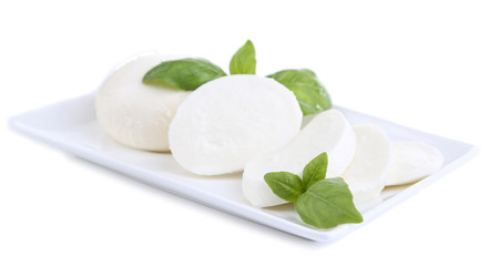 Tasty mozzarella cheese with basil on plate isolated on white © Africa Studio