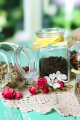 Obraz na płótnie Canvas Assortment of herbs and tea in glass jars