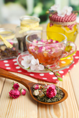 Obraz na płótnie Canvas Assortment of herbs, honey and tea in glass jars
