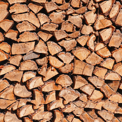 Dry chopped firewood logs in pile.